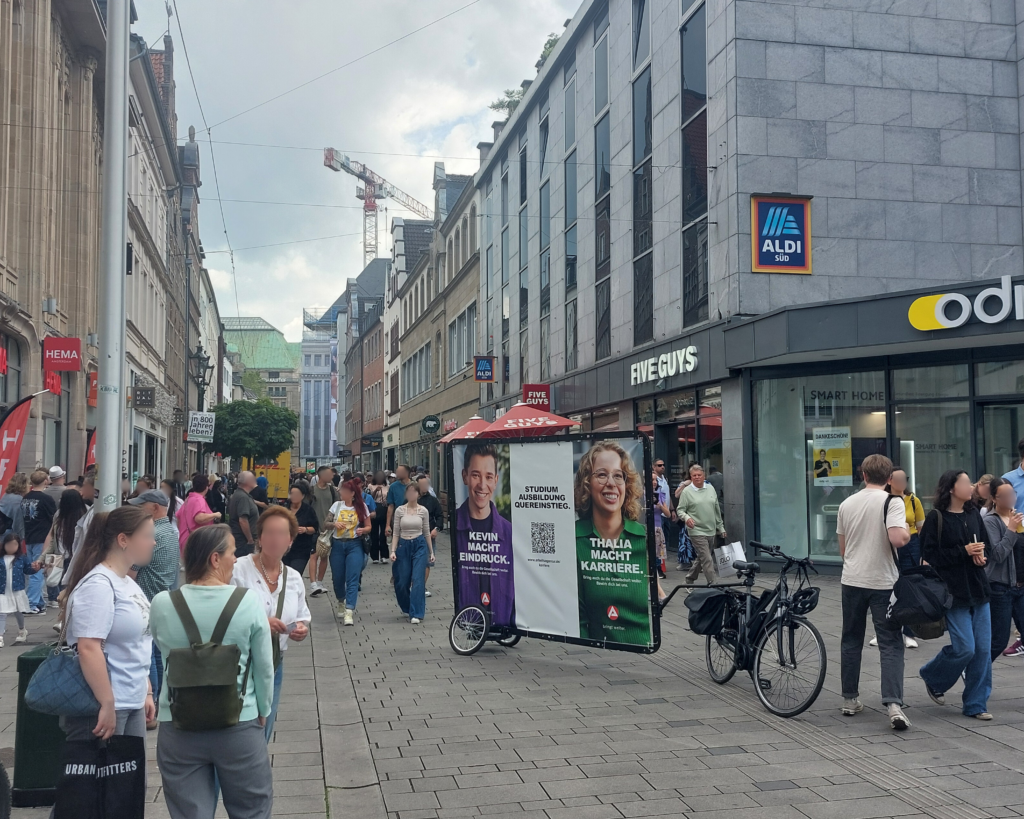 In der Einkaufsstraße von Düsseldorf fallen die großen Werbeträger der Fahrradwerbung auf